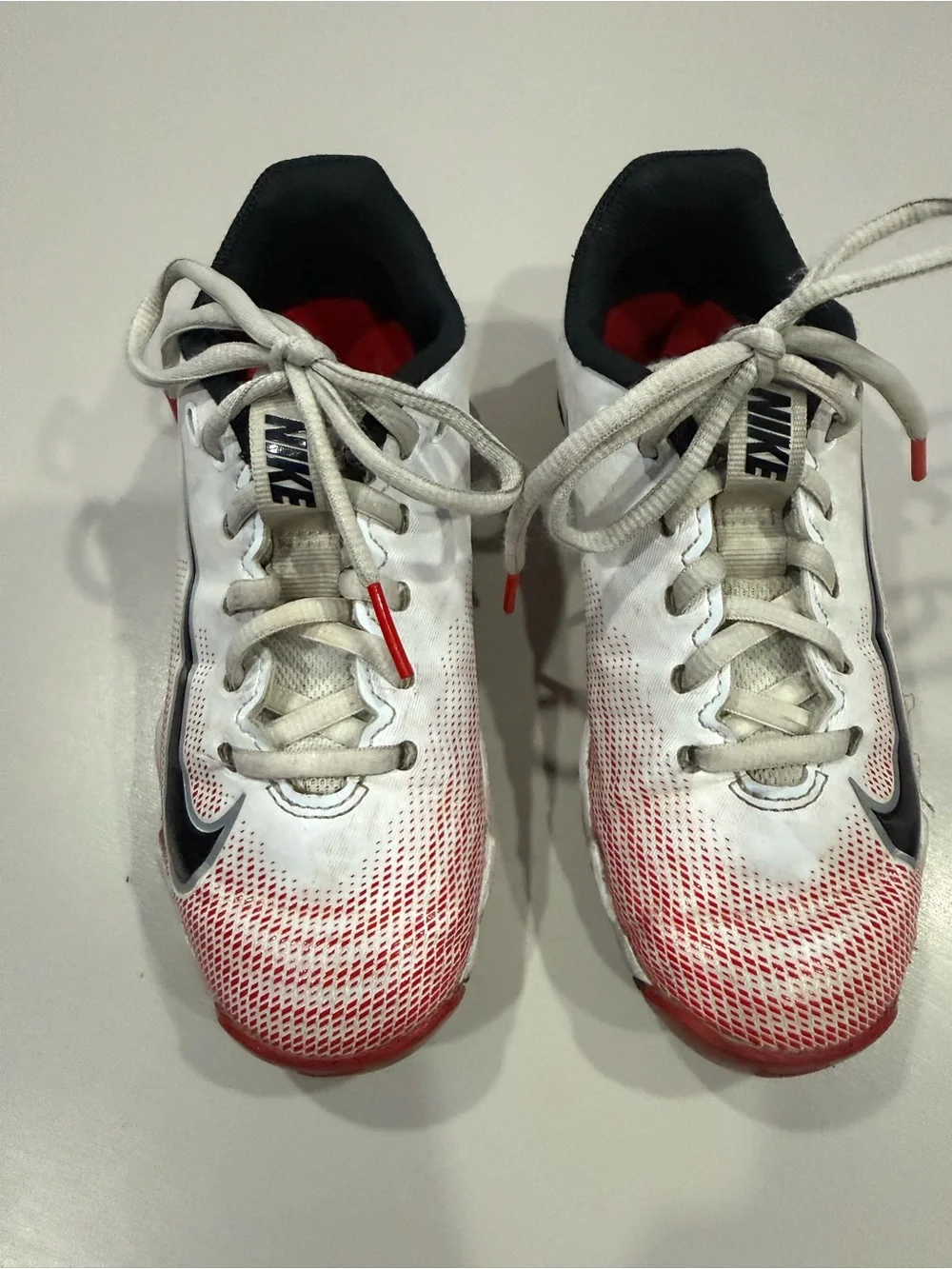 Nike Kids Vapor White and Red Gradient Football Cleats.